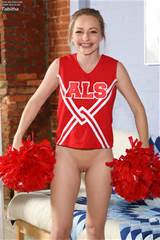Cheerleader In Red Uniform And White Panties Demonstrates Her Shaved