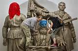 Pussy Riot Punk Group Supporters Place Masks On A Monument To WWII